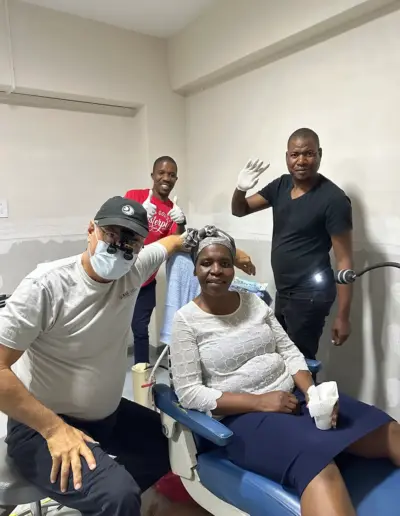 Dental team members posing together in clinical treatment room at Legacy Dental Group.