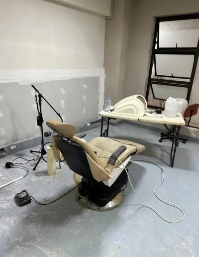 Dental treatment chair and equipment in modern clinic operatory room under construction.